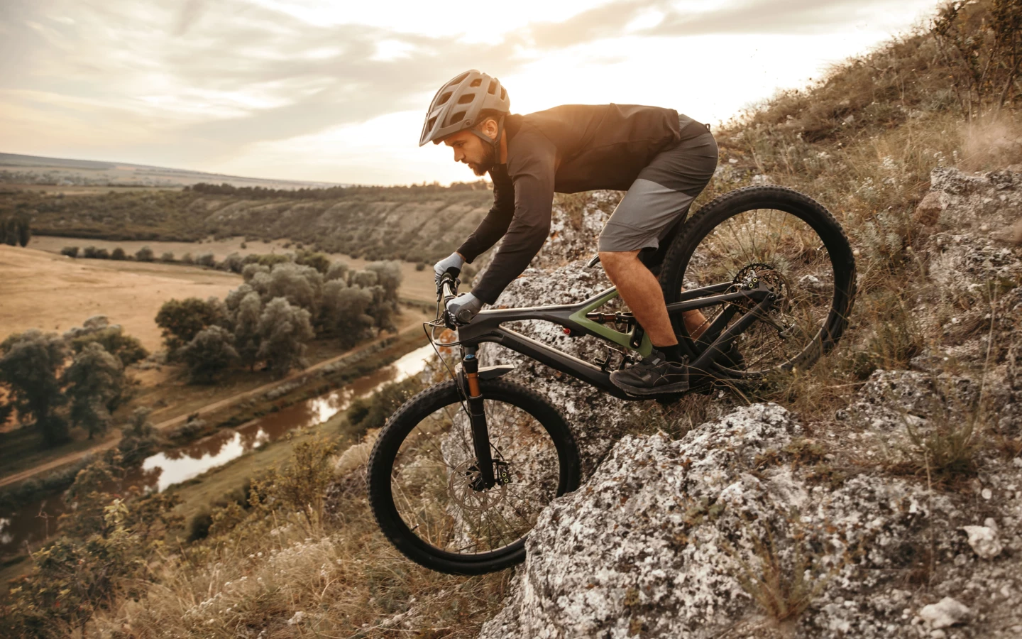 man-riding-downhill-bike-in-mountains