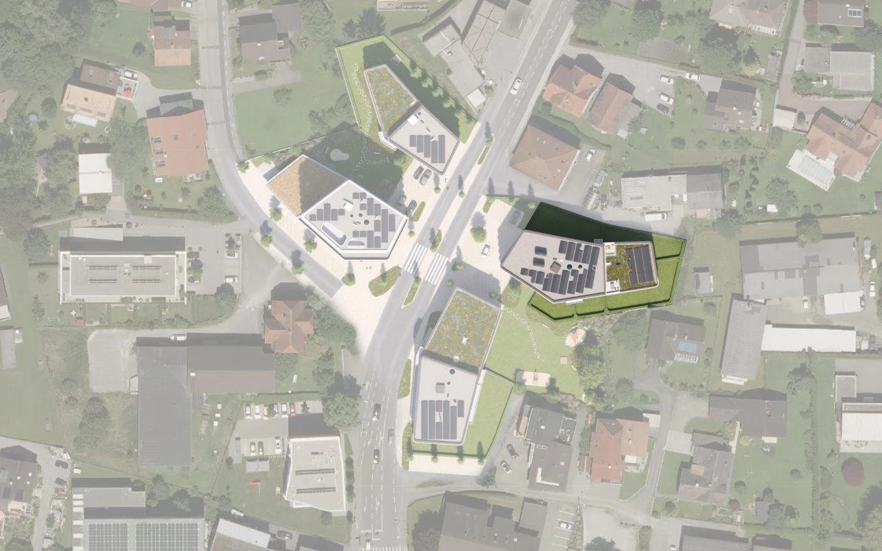 Rheindorf Gesamtansicht: Eine Draufsicht zeigt mehrere moderne Gebäude mit extensiven Gründächern und Photovoltaik-Anlagen, umgeben von Straßen und Grünflächen.