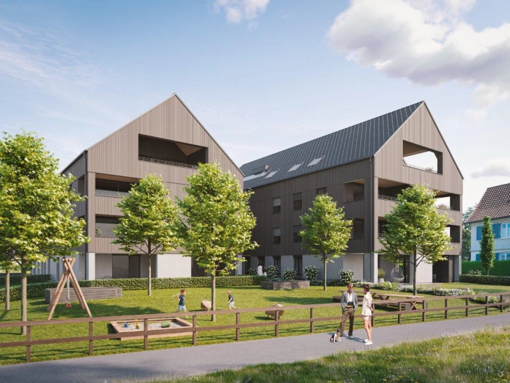 Zwei Mehrfamilienhäuser mit Holzfassade und Spitzdach, Spielplatz und Familie mit Hund TdoT